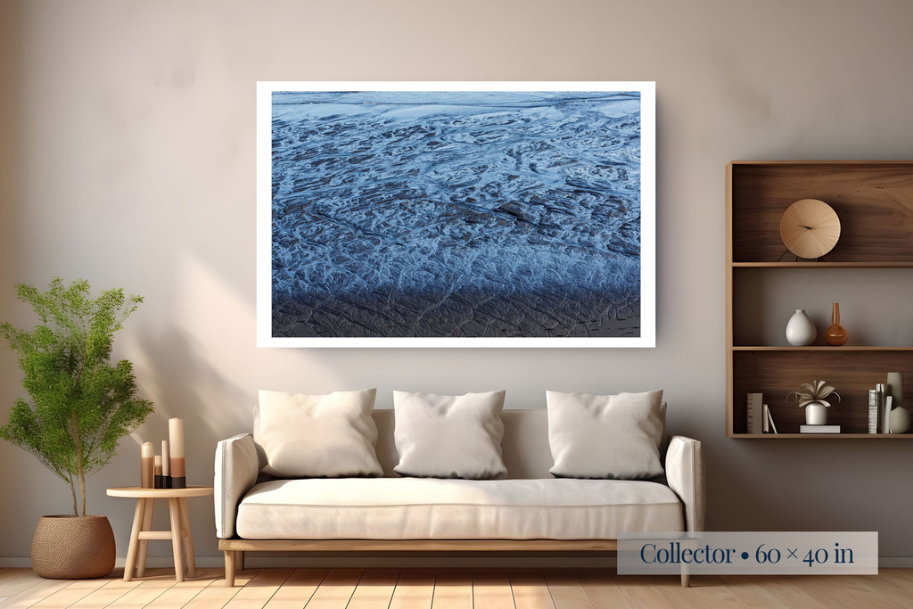 Collector: A Labyrinth of Sand and Sea shown as a Collector 60 × 40-inch print above a sofa.